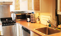 A galley kitchen custom designed and built above an existing garage to provide extra quarters for guests or family.
